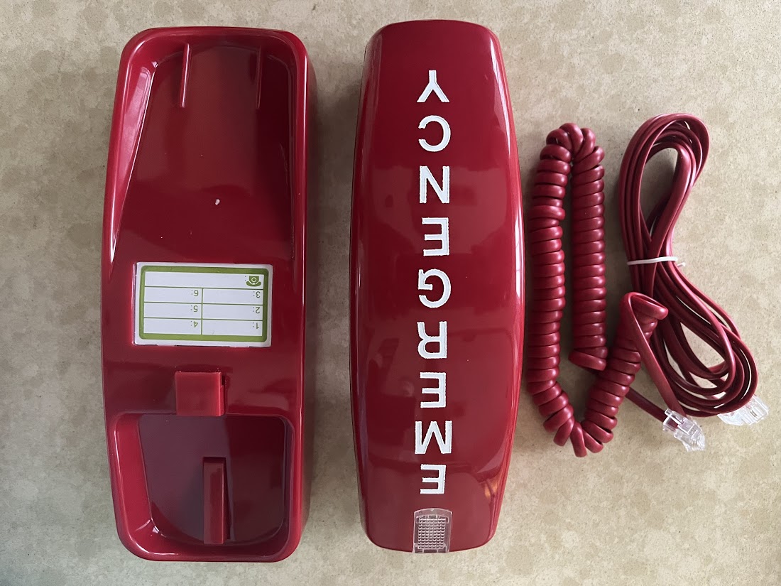 Teléfono de pared o escritorio de emergencia (marcador de línea directa descolgado) de estilo recortado, rojo